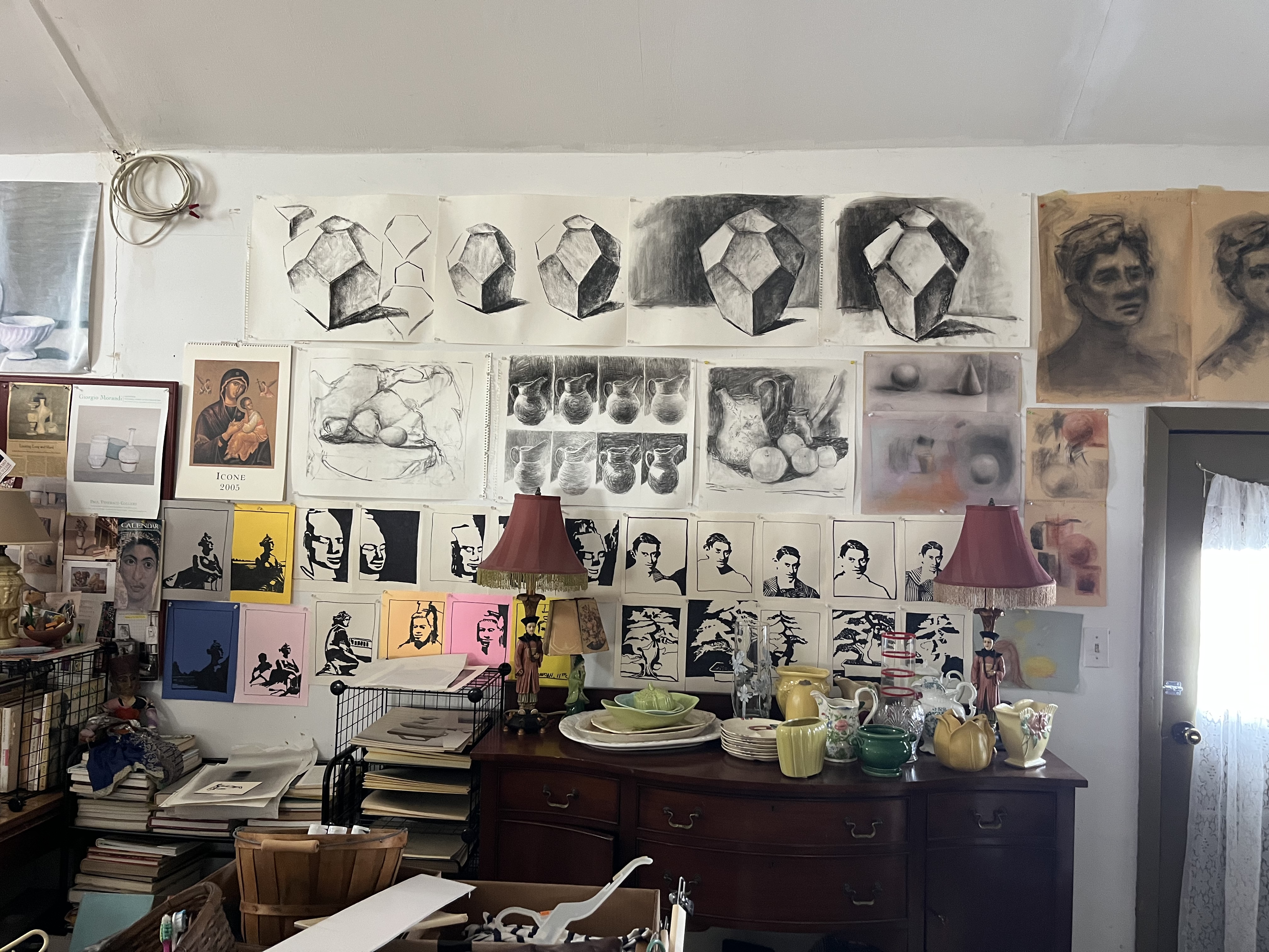The art studio — drawings, prints, studies, and objects covering the walls
